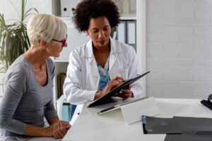 Elederly woman checking in for addiction treatment covered by Medicare.