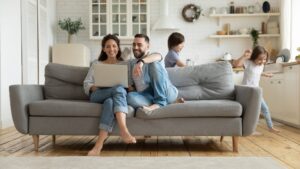 Happy pair of counselors at home with their kids.