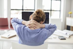 Tired businesswoman holding her nape