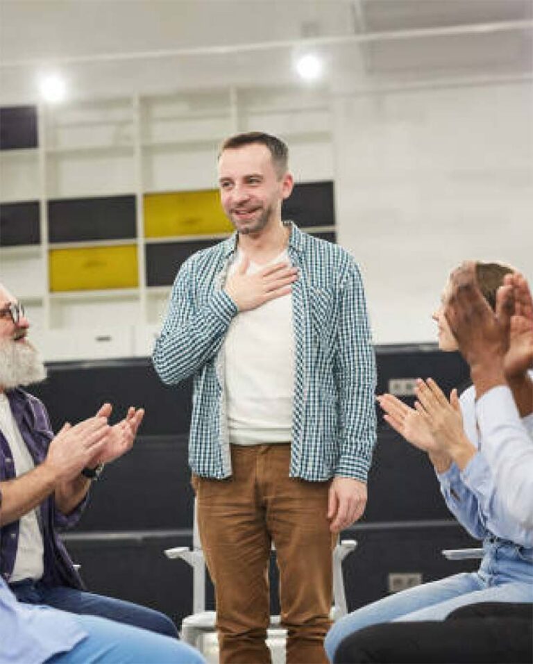 man speaking in front of group