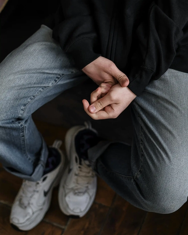 Person sitting with hands in lap