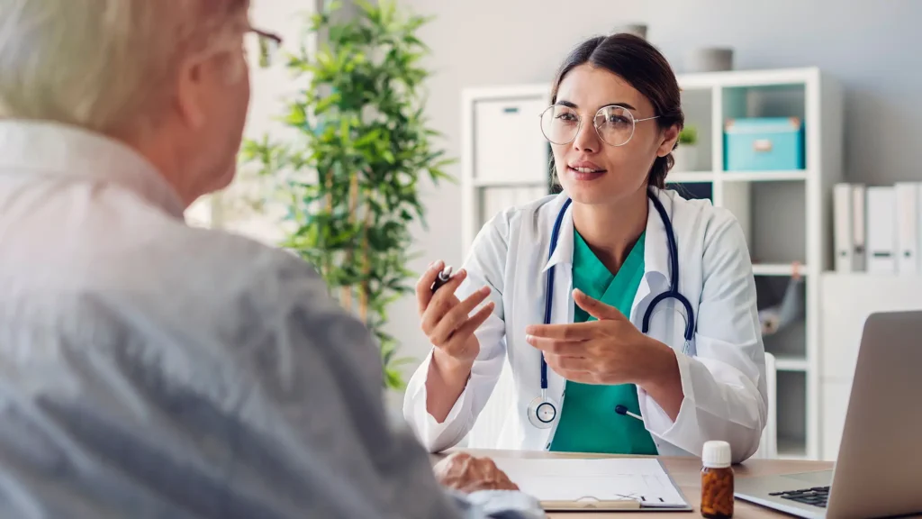 Doctor at a desk speaking with a patient