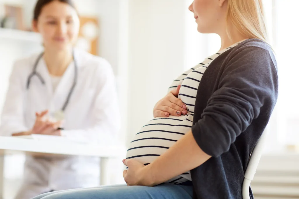 Pregnant woman speaking with a doctor