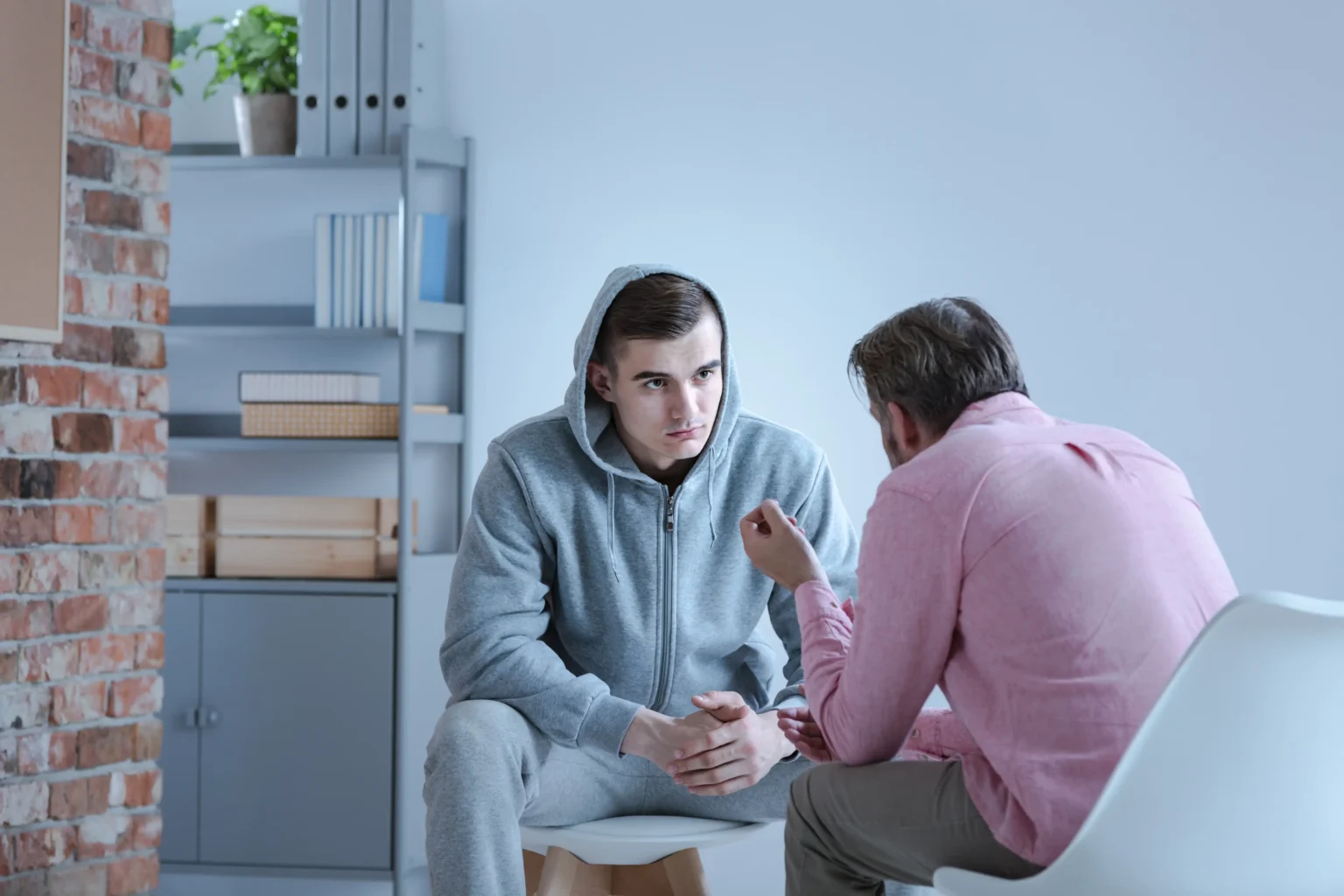 Two people in chairs talking