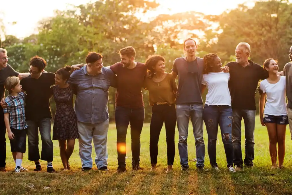 people lined up with arms around each other's shoulders