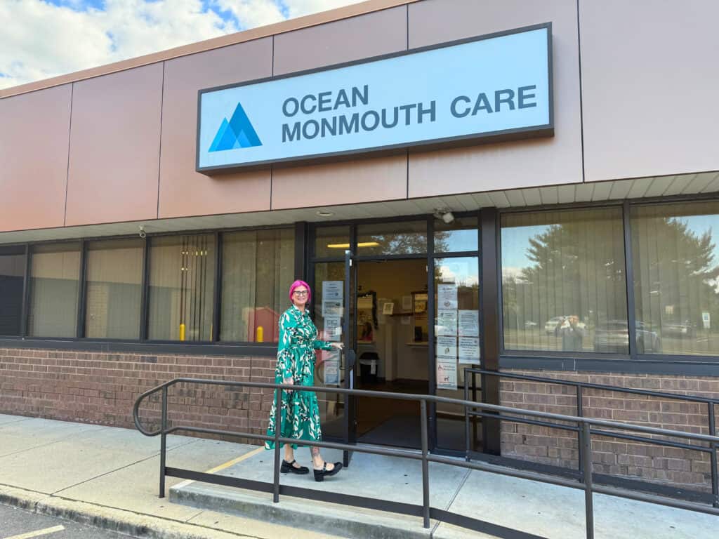 Executive Director in front of Ocean Monmouth Care