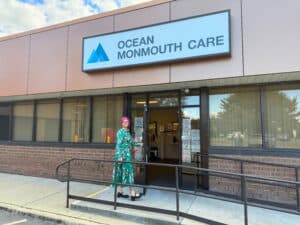 Executive Director in front of Ocean Monmouth Care