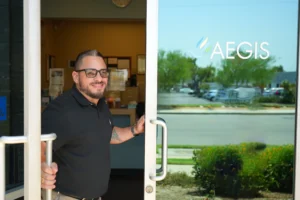 Person standing in doorway of glass sliding door