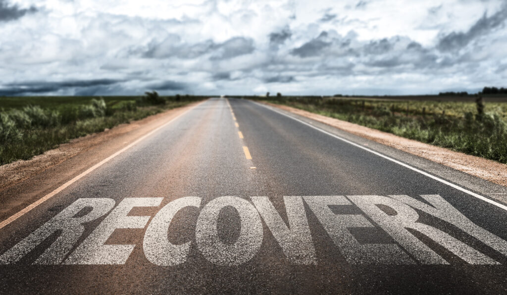 Image of a road with the word "Recovery" superimposed on it.