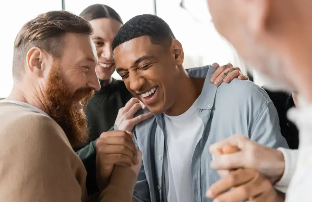 A group of people are smiling and laughing together.