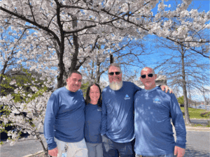 Pinnacle staff standing in front of a tree