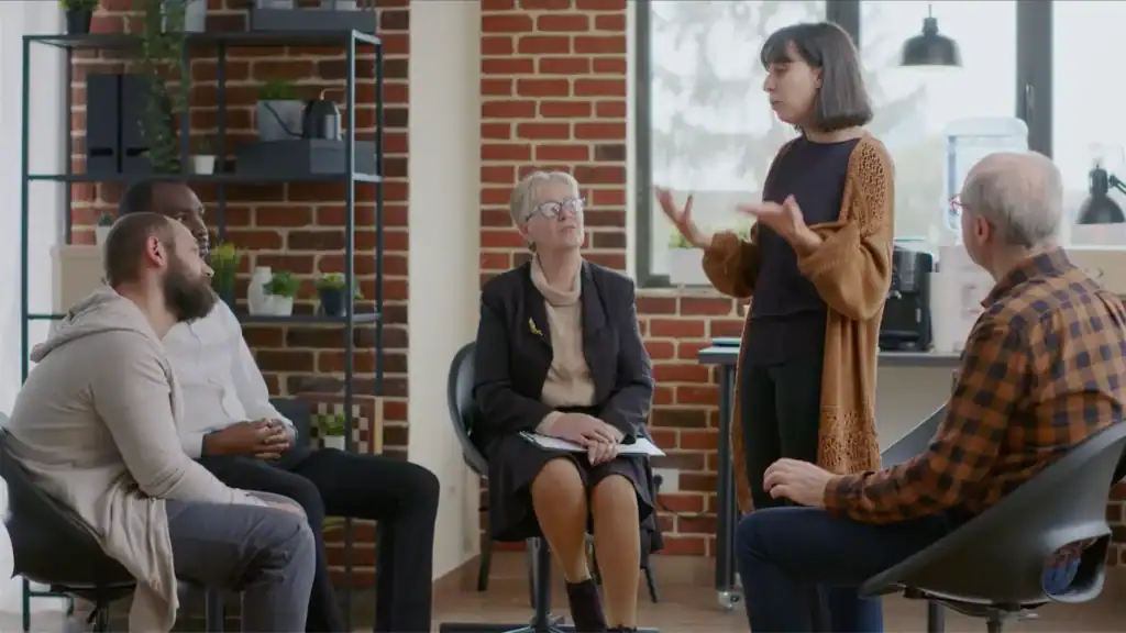 woman speaking in front of group