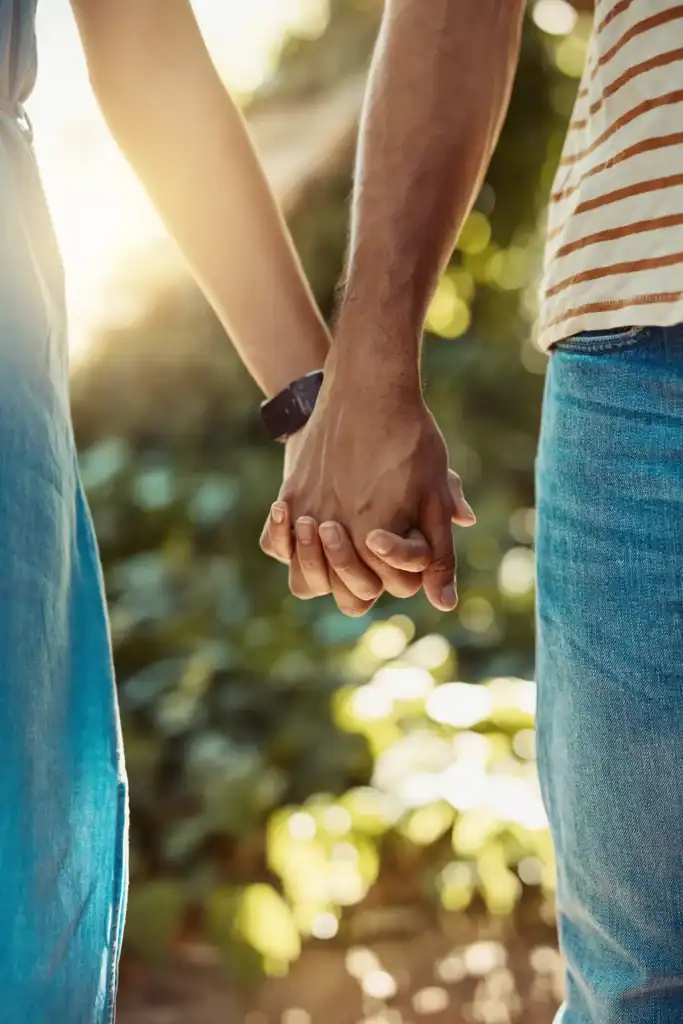 close up of two people holding hands