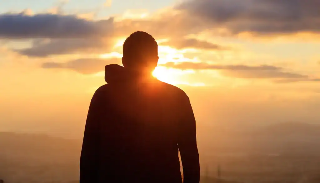 man looking into the sunset