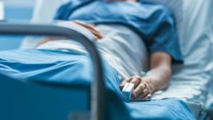 Woman in hospital bed after suffering with opioid addiction.