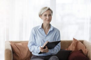 Woman counselor holding a clip book.